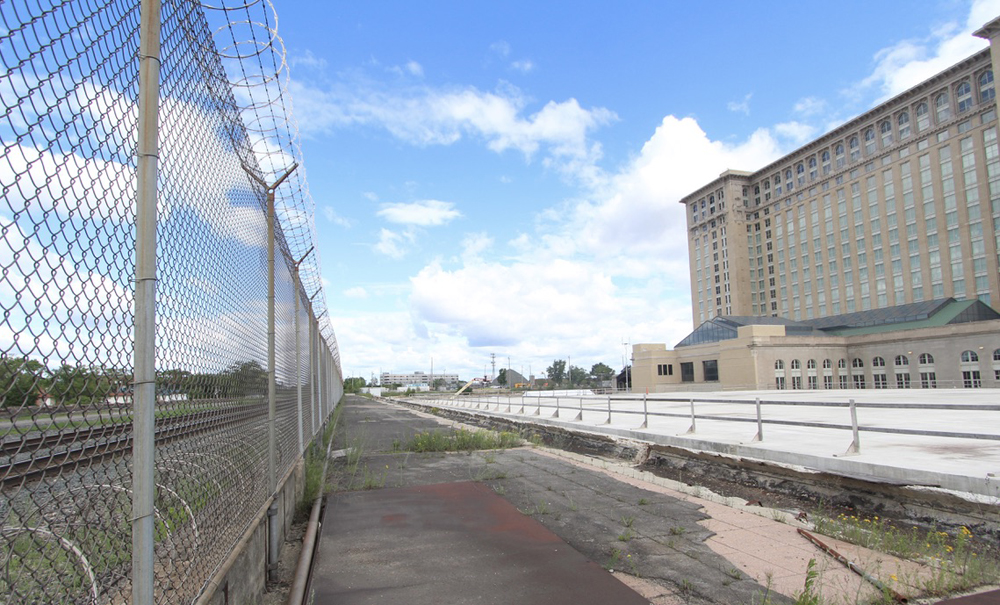 View of area behind Michigan Central station with railroad tracks and large concrete slab