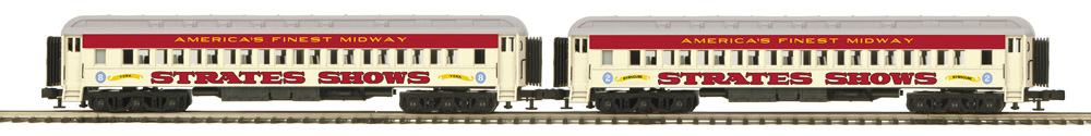 Color photo of two O gauge heavyweights in carnival paint schemes.