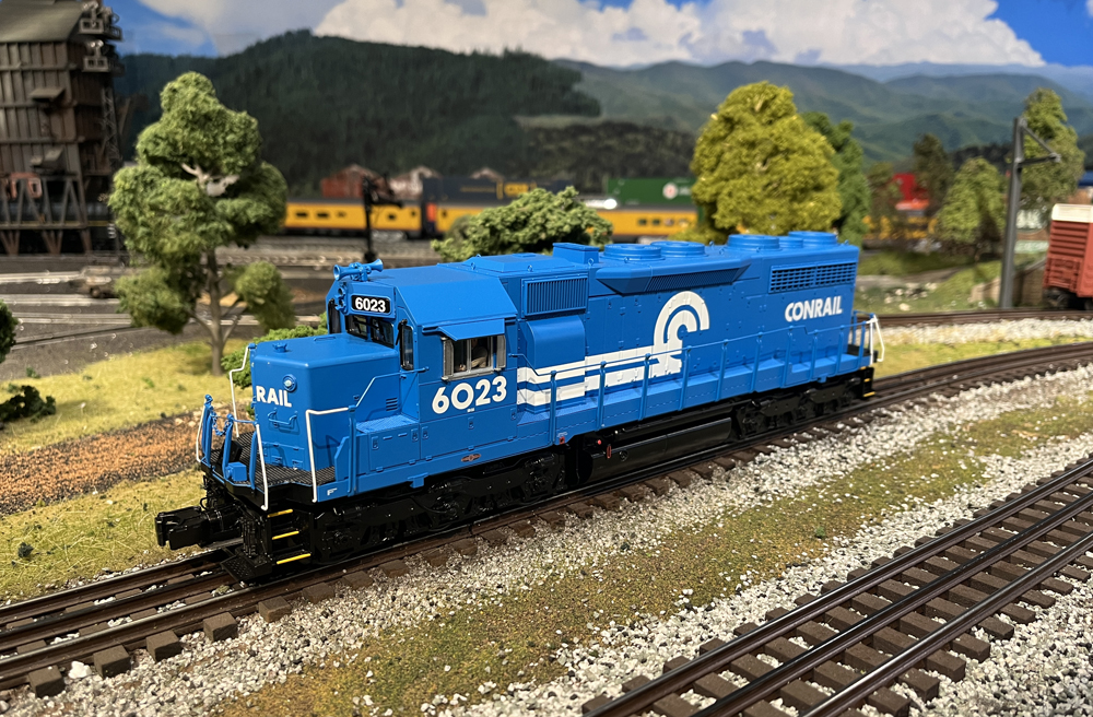 Blue and white model train on layout