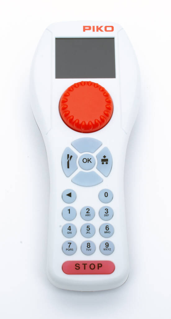 Photo of handheld throttle with buttons, red knob and stop button, and display screen.
