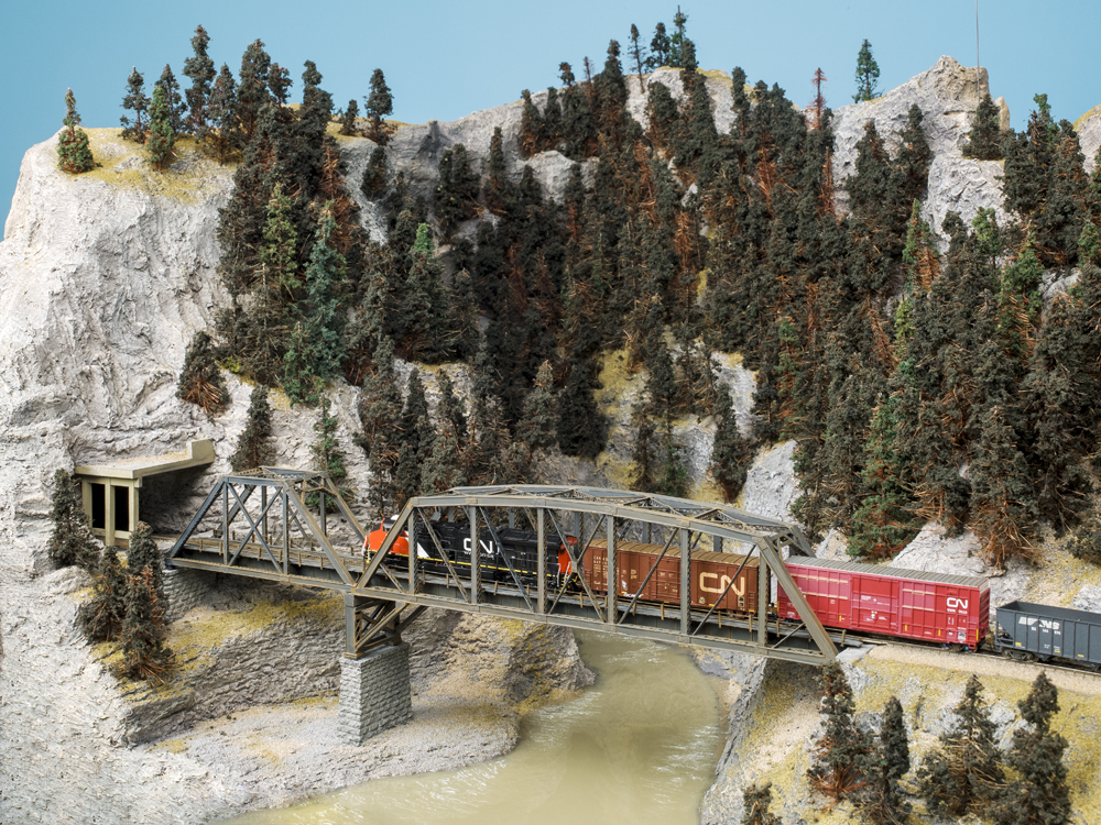 model train on bridge on model train layout