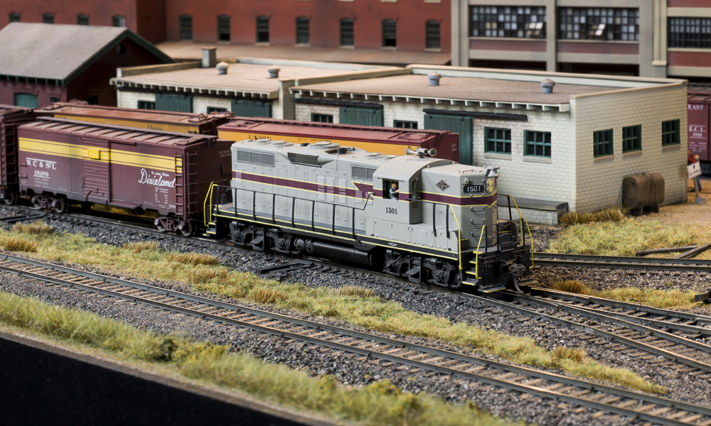 Color photo of HO scale diesel on scenicked layout.