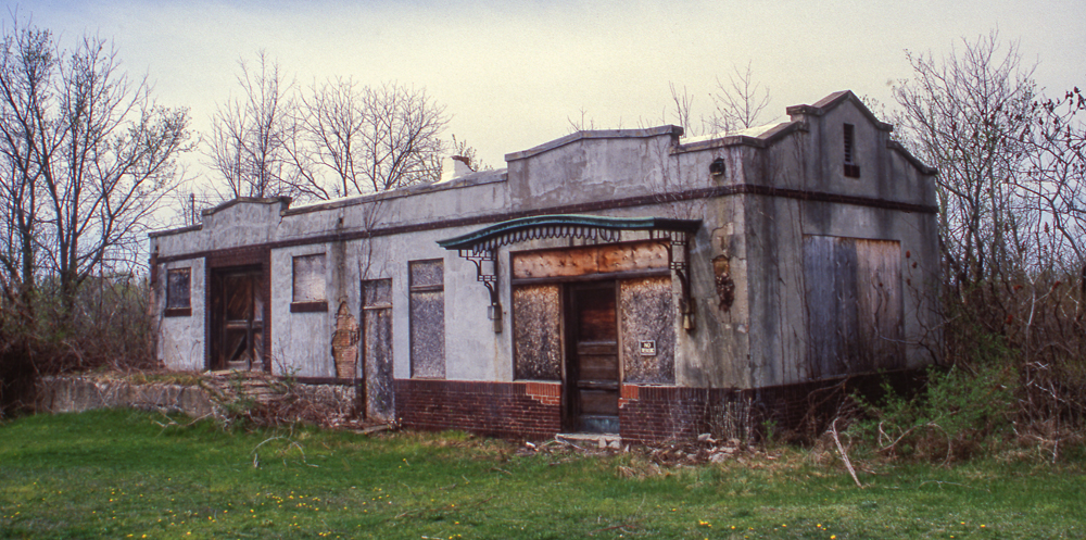 Color image of weather-beaten masonry depot