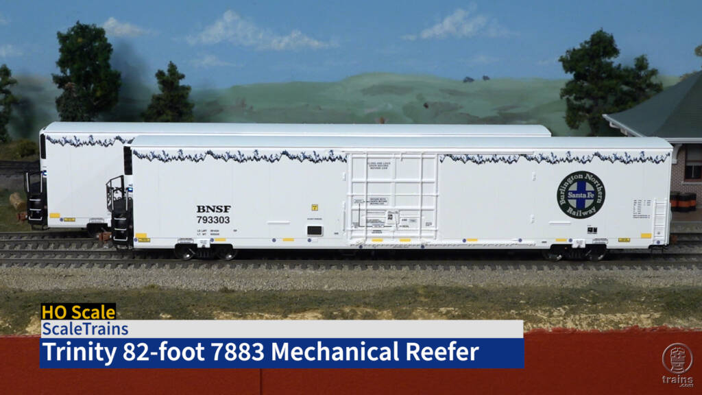 Title screen of review video with two HO scale freight cars painted white with blue and green graphics.