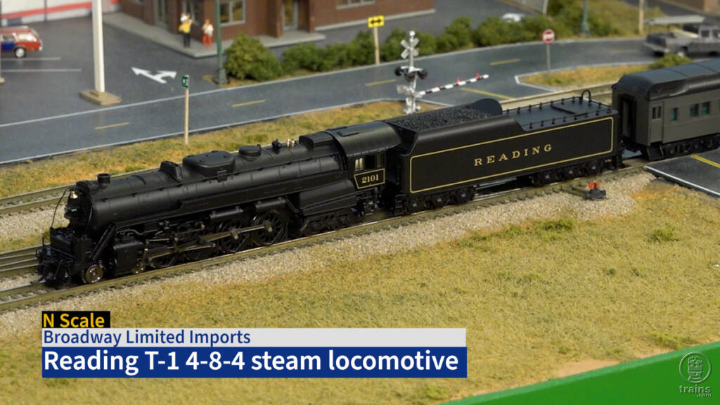 Screen capture of N scale steam locomotive on scenicked model railroad.