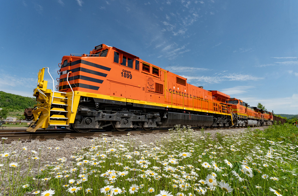 bright orange locomotive on tracks