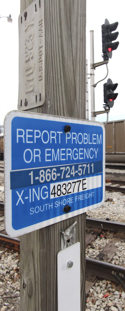 Sign with "Report Problem or Emergency" message and phone number