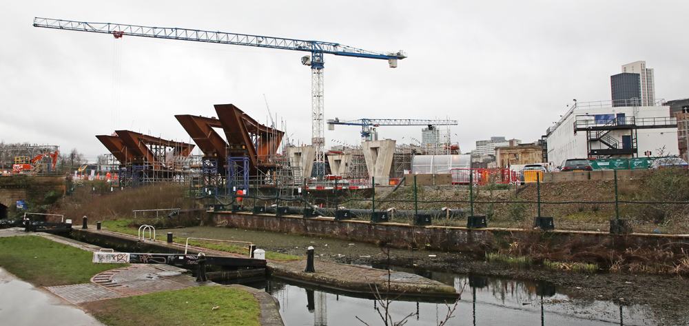 Construction site with bridge piers and large cranes