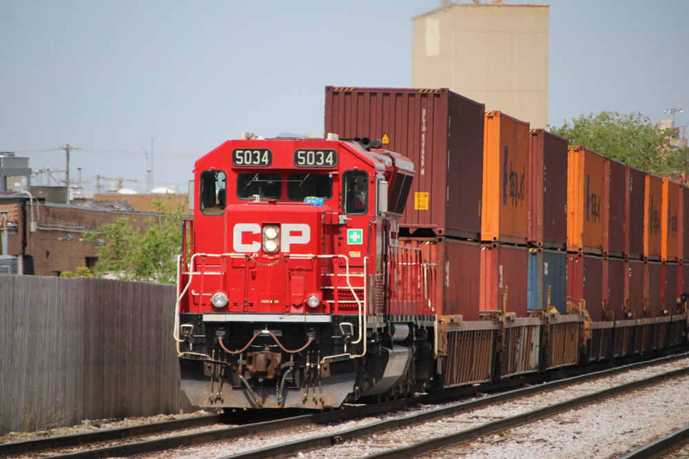 Red locomotive with double-stack container cars
