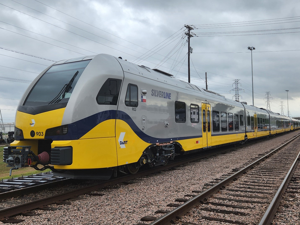 Silver and yellow diesel multiple unit trainsets