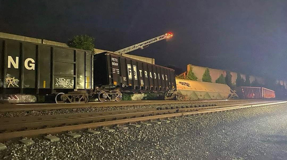 Derailed freight cars at night