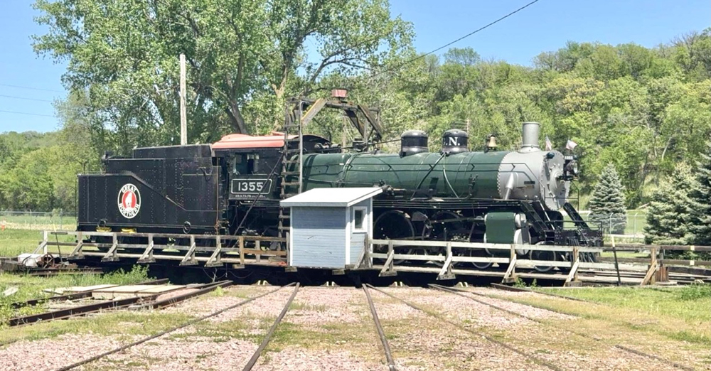 Steam locomotive with green boiler jacket on turntable
