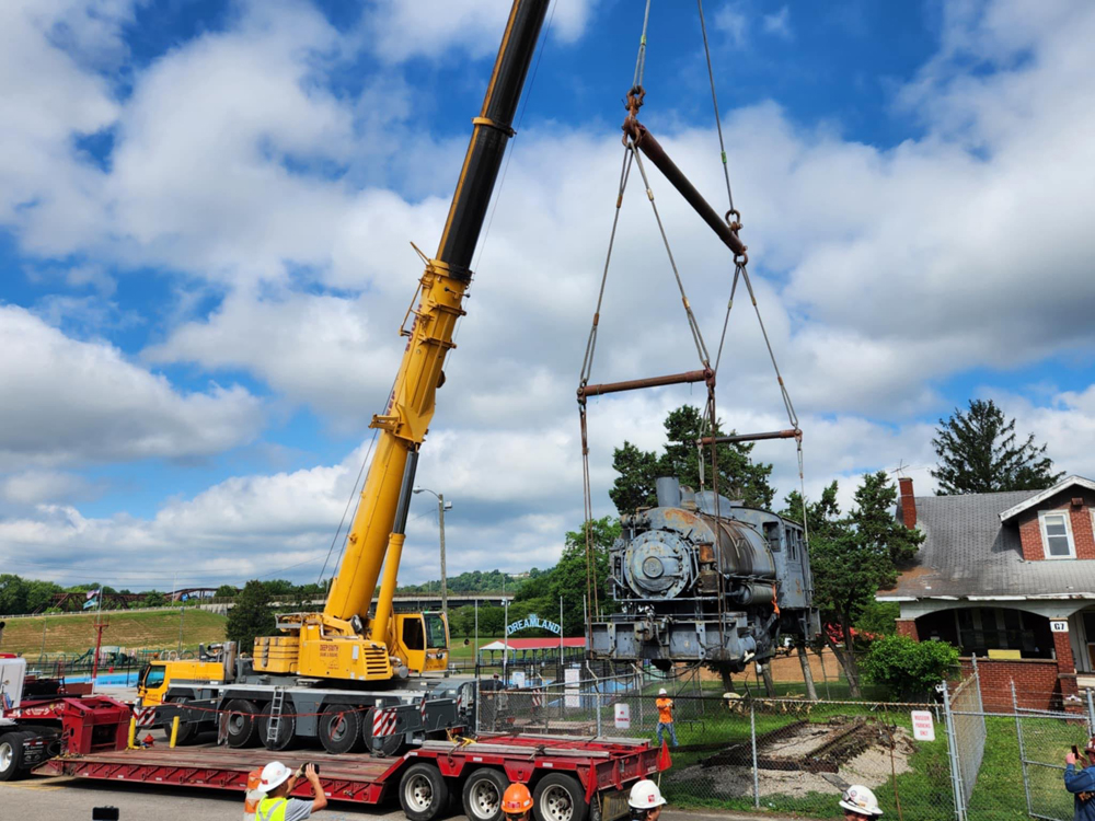 Steam locomotive being lifted by crane