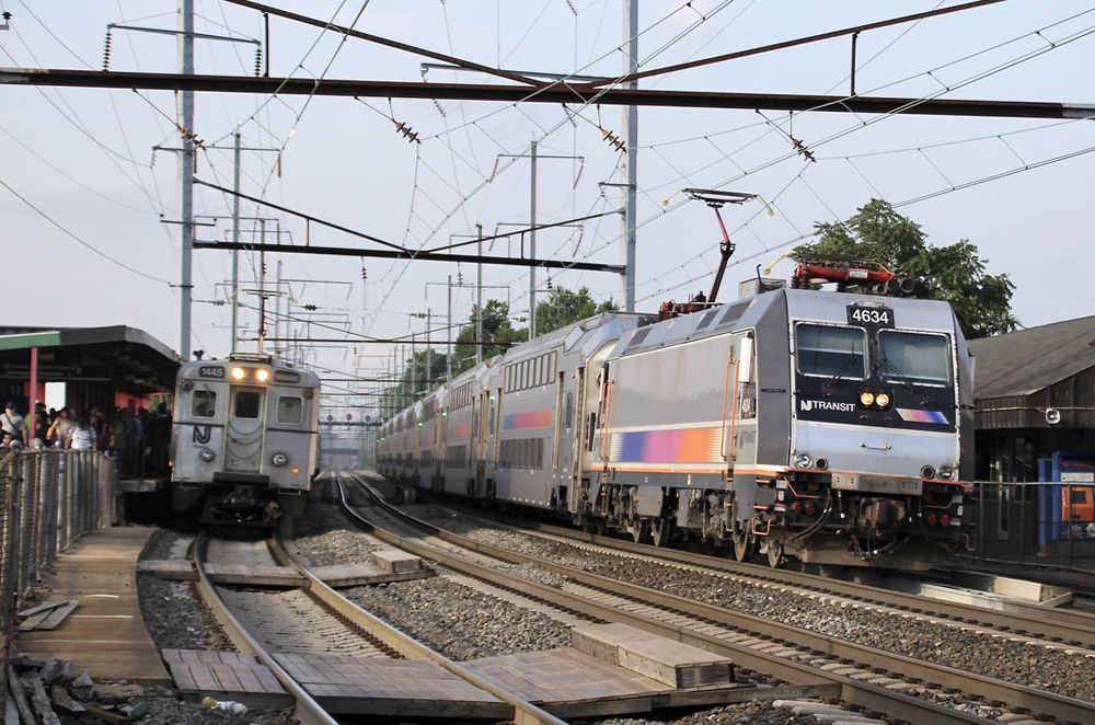 Two commuter trains at station on curve