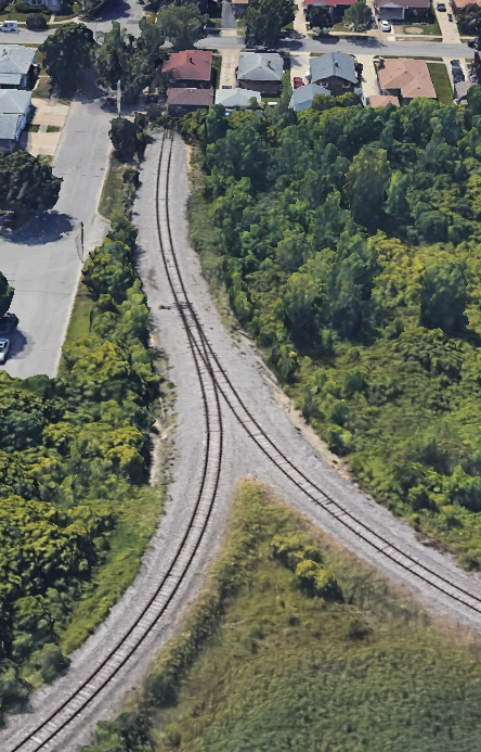 Aerial view of legs of wye, with end of track pointing to garage behind house