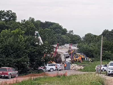Distant view of pile of derailed railcars