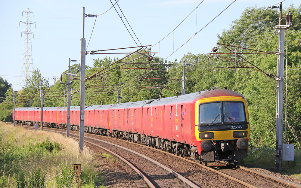 Red mostly windowless electric trains on curve