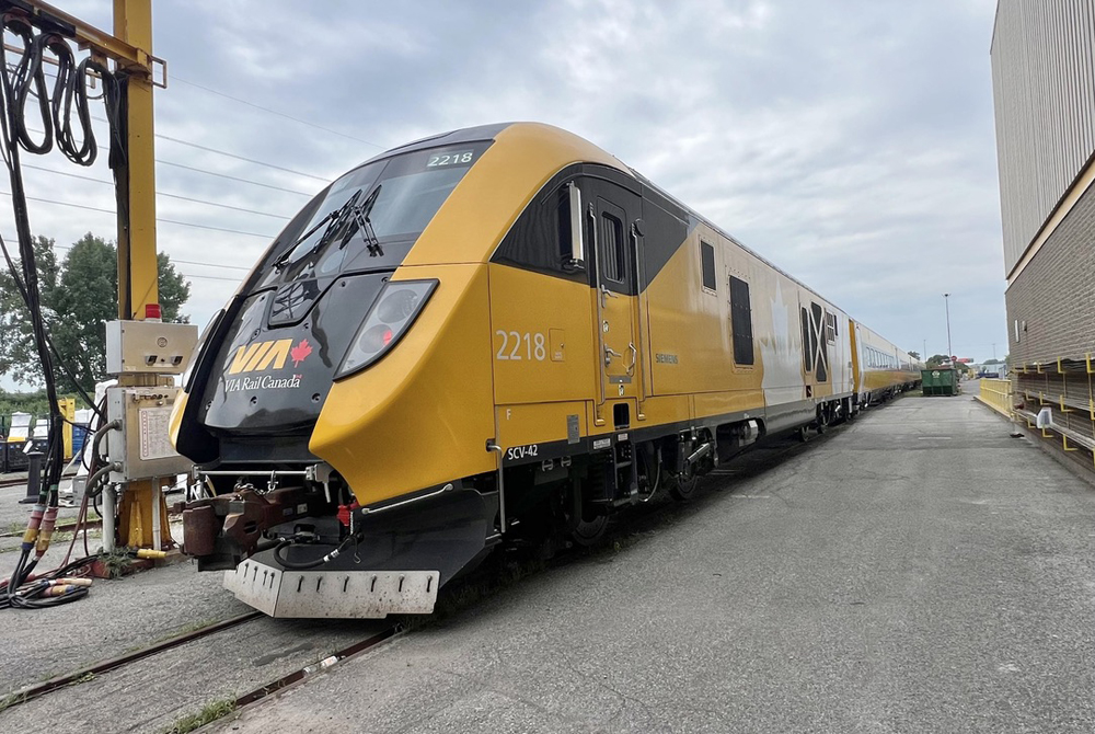 Yellow Siemens Charger locomotive in yard