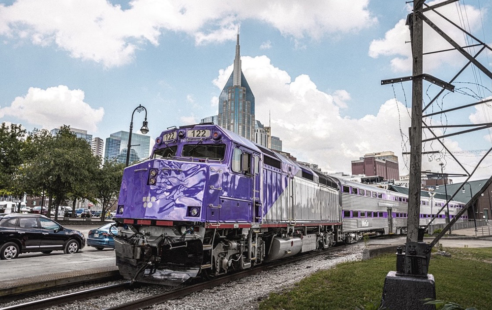 Commuter train with purple and silver locomotive