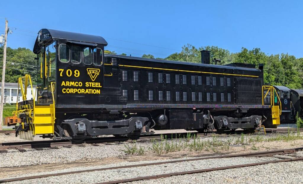 Black end-cab switcher with yellow stripes and lettering