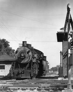 Steam locomotive with freight train by tower