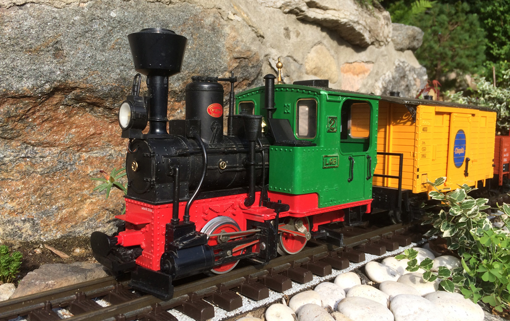 A toy train in an outdoor setting