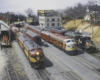 Photo of trains on model railroad at station scene.
