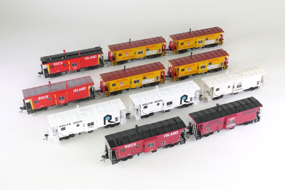 A collection of model cabooses in various paint schemes