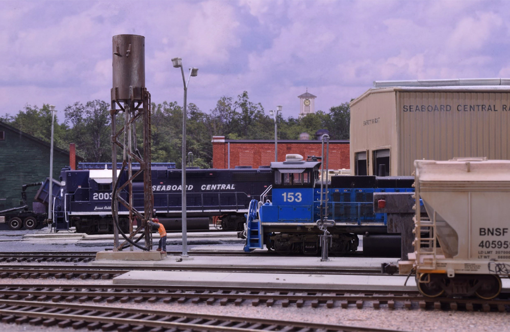 blue model locomotive on train layout