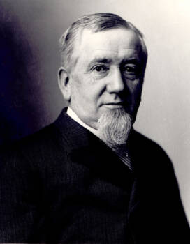 Man from the 1800s in a black suit.