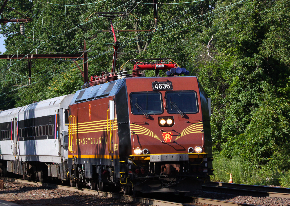 Tuscan Red and gold stripped modern electric passenger locomotive.