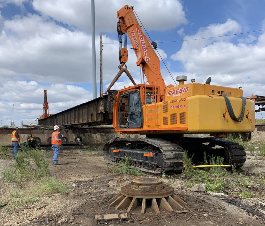 Heavy equipment lifts turntable out of pit