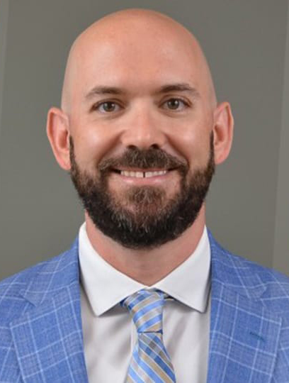 Man in light blue coat and tie