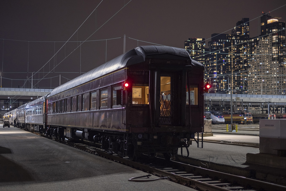 Heavyweight passenger car in yard with modern equipment in snow