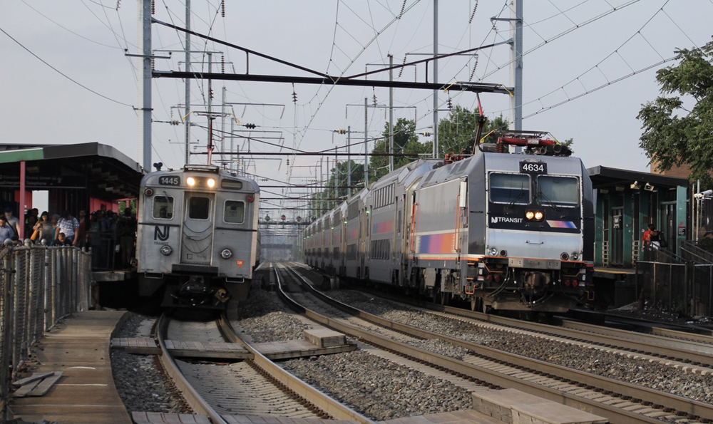 Commuter trains on two tracks of three-track line at station