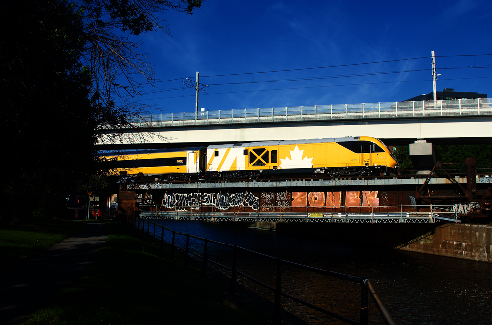 Yellow train crosses bridge