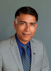 Head shot of man in coat and tie