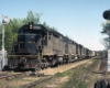 Black diesel Atlanta & West Point locomotives with freight train between signals