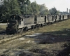 Five black diesel Atlanta & West Point locomotives with train