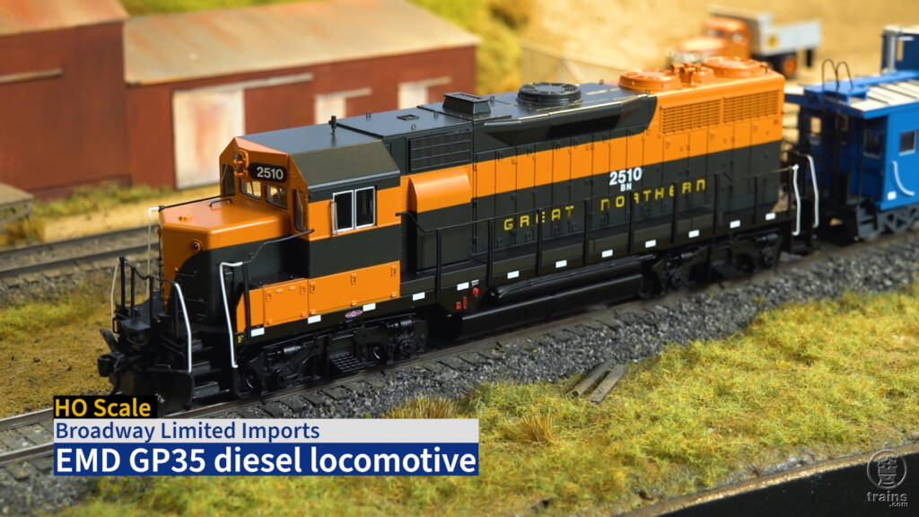 Screen capture from Product Review video showing HO scale diesel painted orange and green.