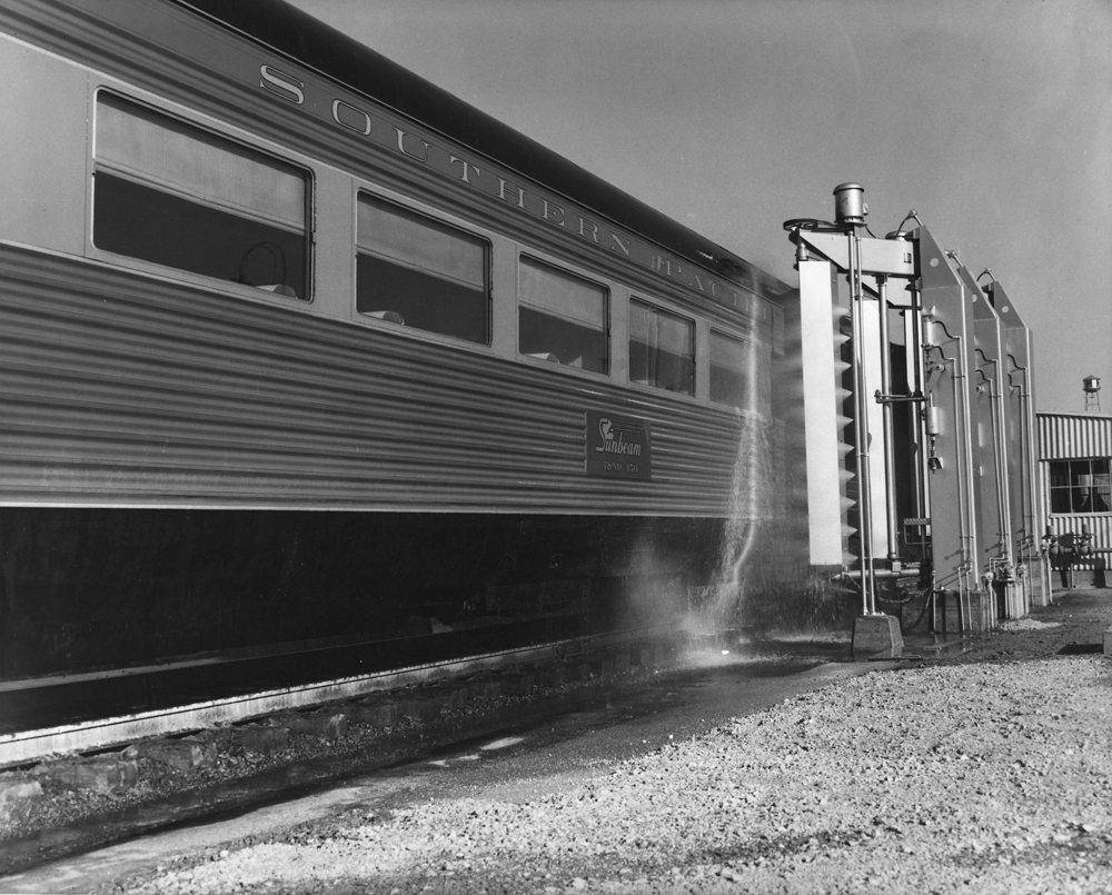 Black-and-white image of passenger car going through washer