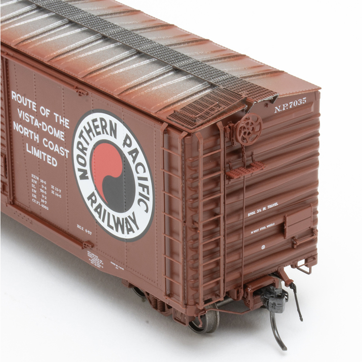 Color photo of HO scale boxcar painted brown and silver.