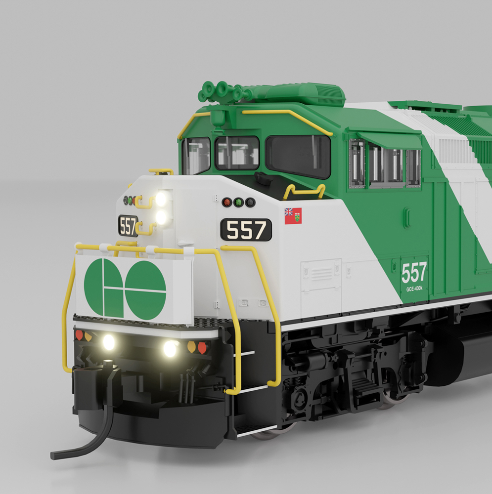 A green and white model locomotive against a gray background