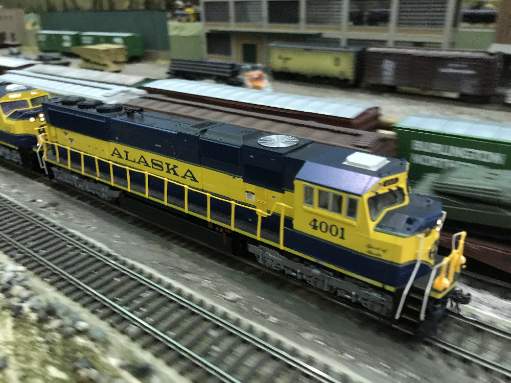 blue and yellow model railroad locomotive