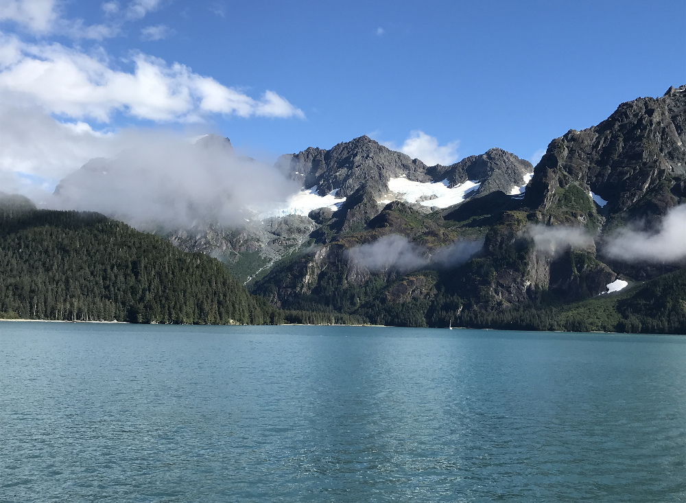 Three glaciers in mountains.