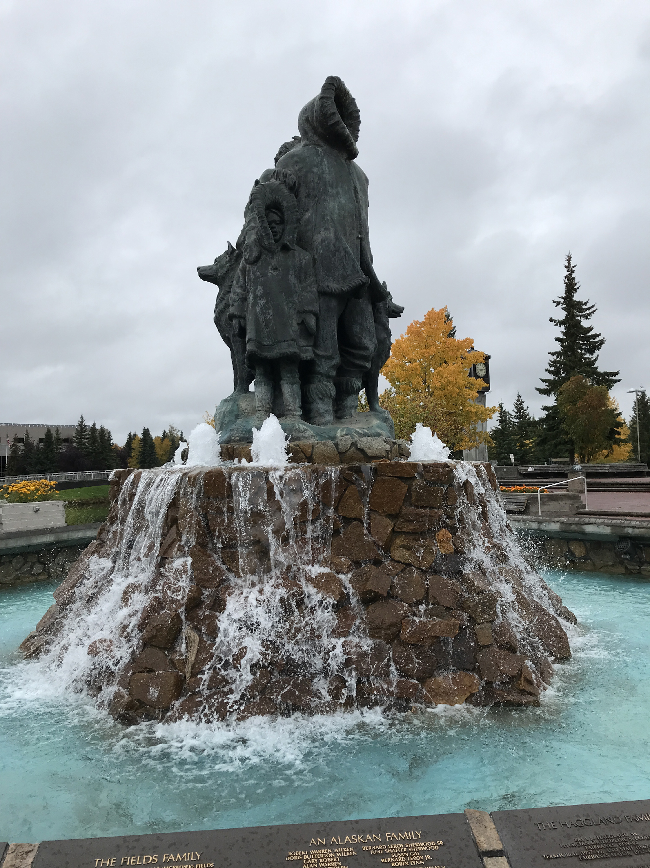 Statue atop a fountain in a city park. Alaska by Rail adventure.