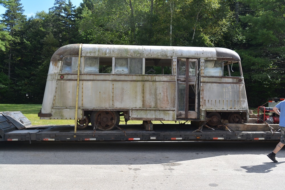 Old looking trolley/bus vehicle sitting on a trailer with Evans Auto-Railer to join National Capital Trolley Museum’s collection