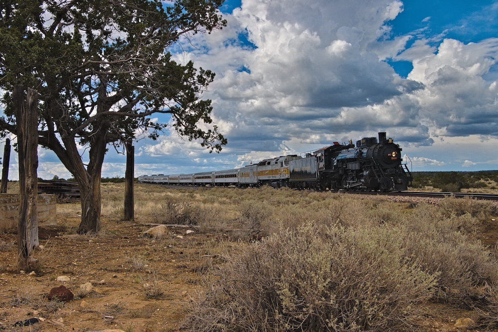 Steam powered passenger train running across a desert-like landscape as Grand Canyon No. 4960 operates first of two September steam safaris 