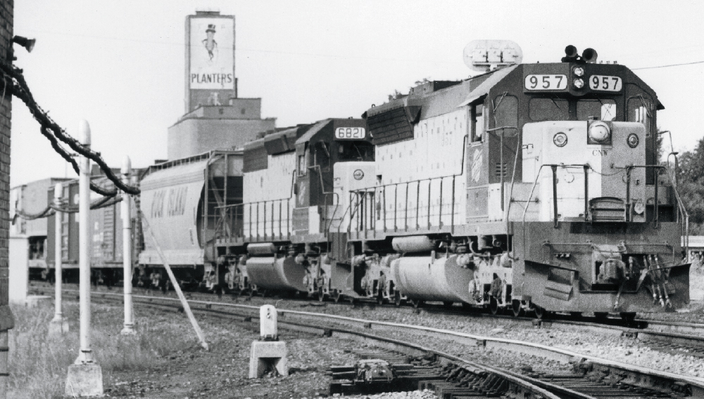 Black and white photo of Chicago & North Western SD45 pulling a freight train. The farmer's frying pan.