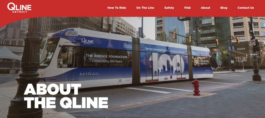 Advertising-wrapped blue streetcar on city street